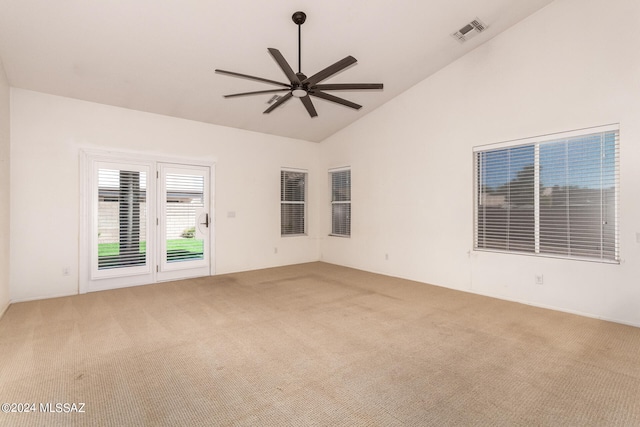 empty room featuring ceiling fan, carpet floors, and vaulted ceiling