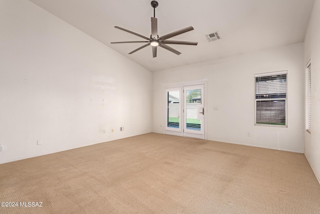 unfurnished room featuring light colored carpet, vaulted ceiling, ceiling fan, and visible vents