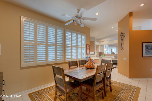 dining room with lofted ceiling, ceiling fan, light tile patterned floors, and sink