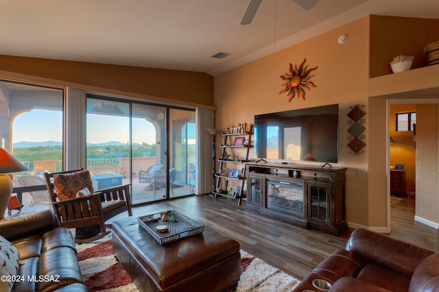 living room with vaulted ceiling, ceiling fan, hardwood / wood-style flooring, and a healthy amount of sunlight