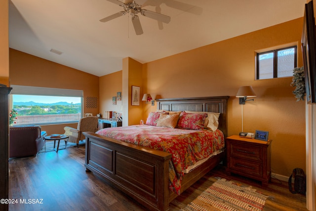 bedroom with lofted ceiling, multiple windows, ceiling fan, and dark hardwood / wood-style flooring