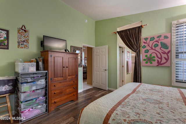 bedroom with dark wood-type flooring