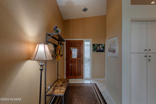 tiled entrance foyer with vaulted ceiling