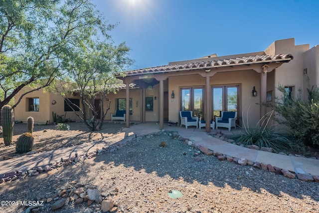 back of property with a patio