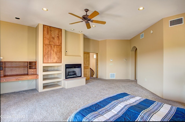 unfurnished bedroom with carpet floors, a fireplace, and visible vents