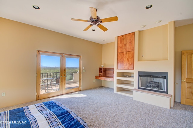 unfurnished bedroom with access to exterior, french doors, carpet floors, a fireplace, and recessed lighting