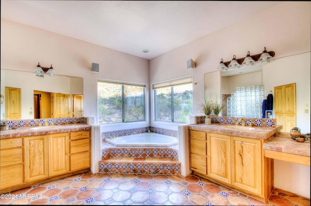 bathroom featuring a garden tub, two vanities, a sink, and tile patterned flooring