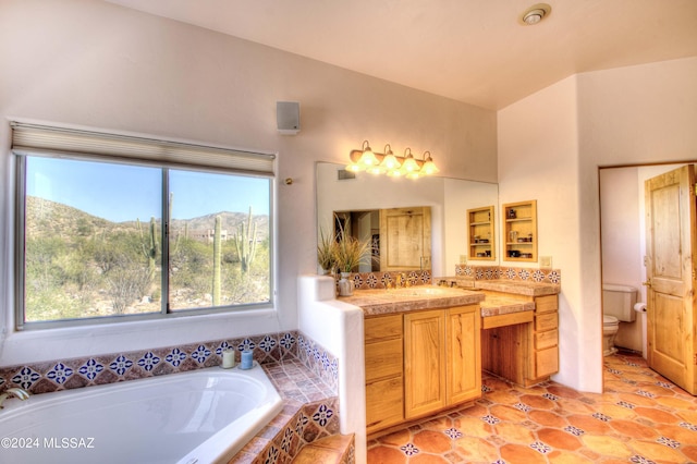 full bathroom with tile patterned flooring, vanity, toilet, and a bath