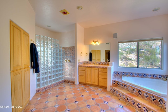 full bathroom with walk in shower, a bath, and vanity