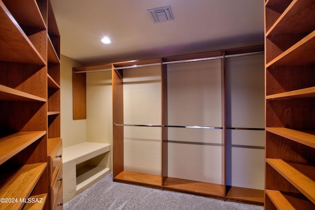 spacious closet with carpet flooring and visible vents