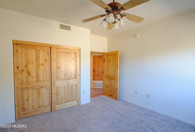 unfurnished bedroom featuring ceiling fan, carpet, and visible vents