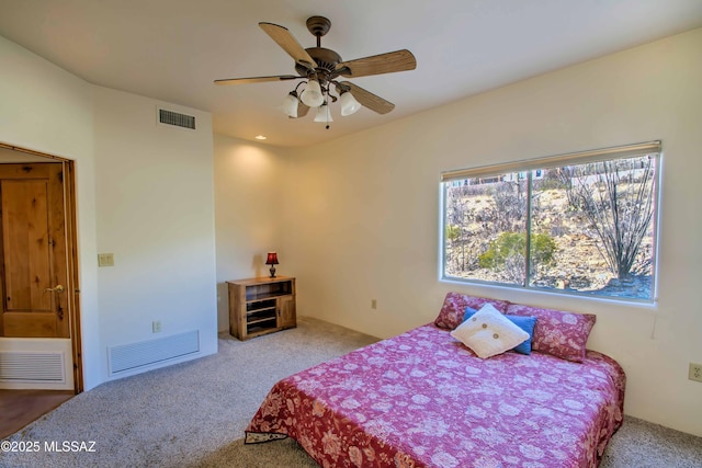 bedroom featuring a ceiling fan, visible vents, and carpet flooring