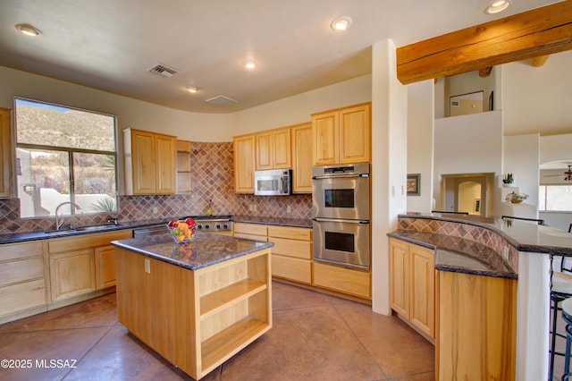 kitchen with appliances with stainless steel finishes, open shelves, and light brown cabinetry