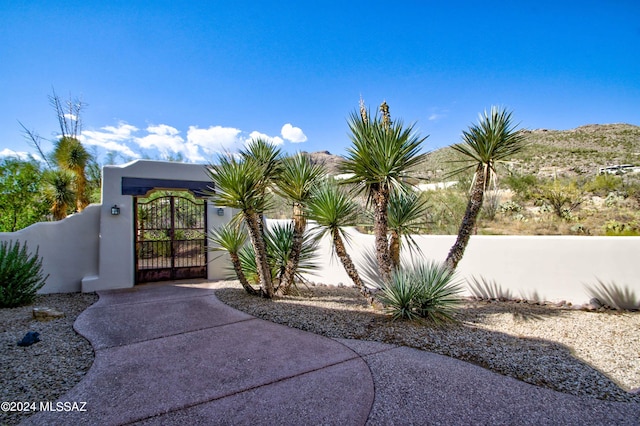 exterior space with a fenced front yard and a gate