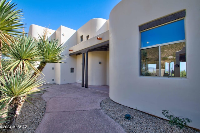 exterior space with a patio area and stucco siding