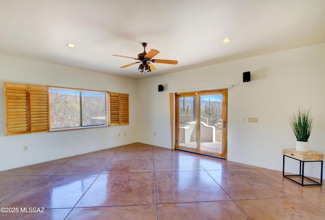 spare room with a ceiling fan, recessed lighting, and concrete floors