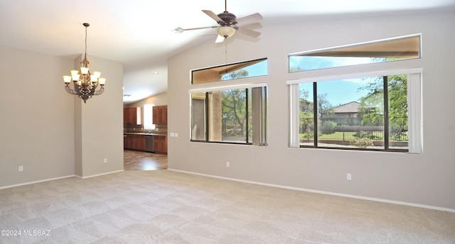 empty room featuring light colored carpet, vaulted ceiling, and a wealth of natural light