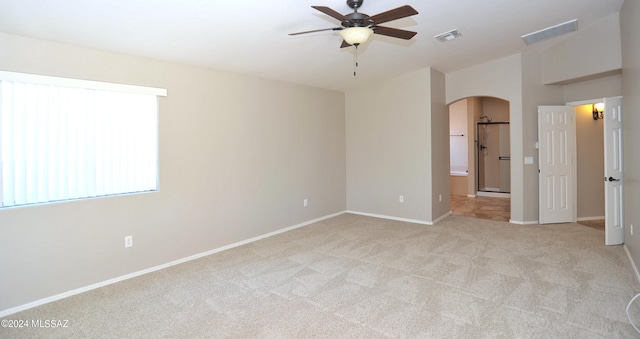 carpeted empty room featuring ceiling fan