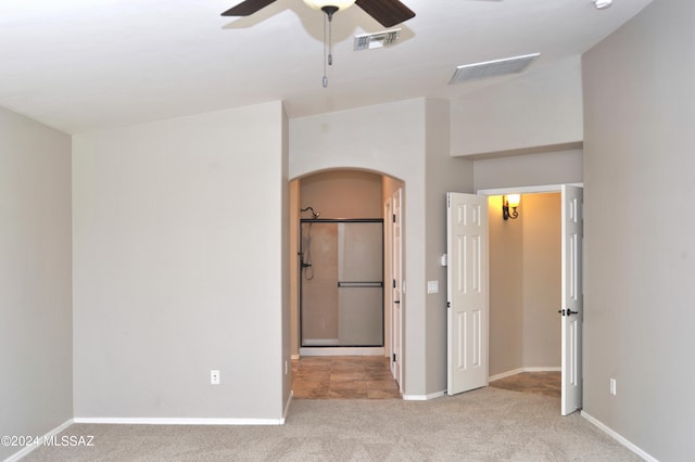 unfurnished bedroom with ceiling fan and light colored carpet