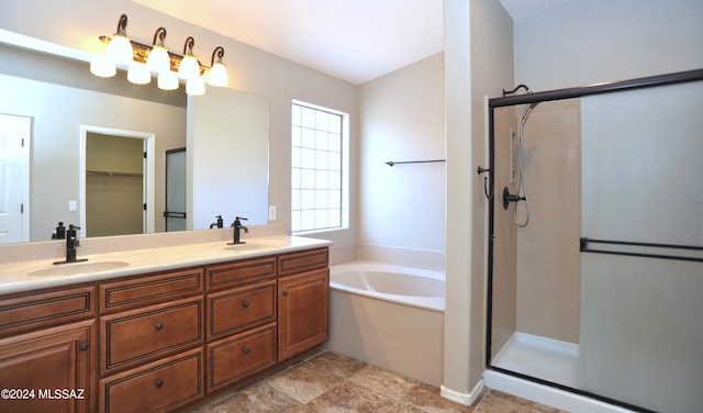 bathroom featuring vanity and shower with separate bathtub