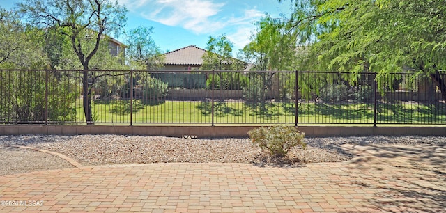 view of gate with a lawn