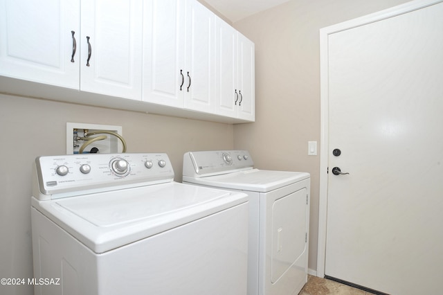 laundry room with washer and clothes dryer and cabinets