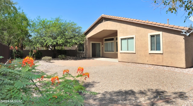 rear view of property featuring a patio area