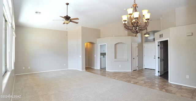 carpeted spare room with a high ceiling, washer / clothes dryer, and ceiling fan with notable chandelier