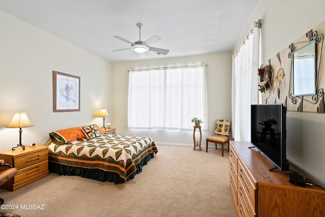 bedroom featuring ceiling fan, baseboards, multiple windows, and carpet floors