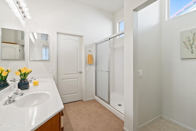 bathroom featuring a shower with door and vanity