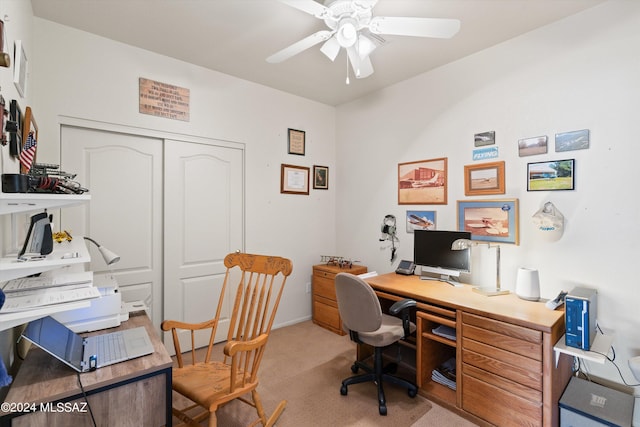 office featuring light carpet, ceiling fan, and baseboards