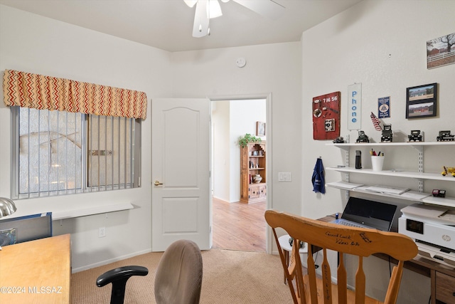 home office with light colored carpet, baseboards, and ceiling fan