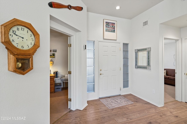 entrance foyer featuring visible vents, baseboards, and wood finished floors