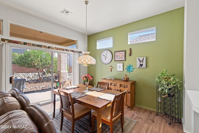 dining room featuring wood-type flooring and a wealth of natural light