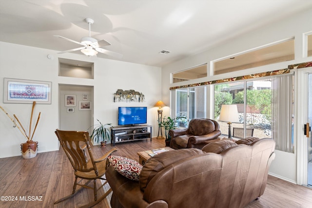 living room featuring ceiling fan and hardwood / wood-style flooring