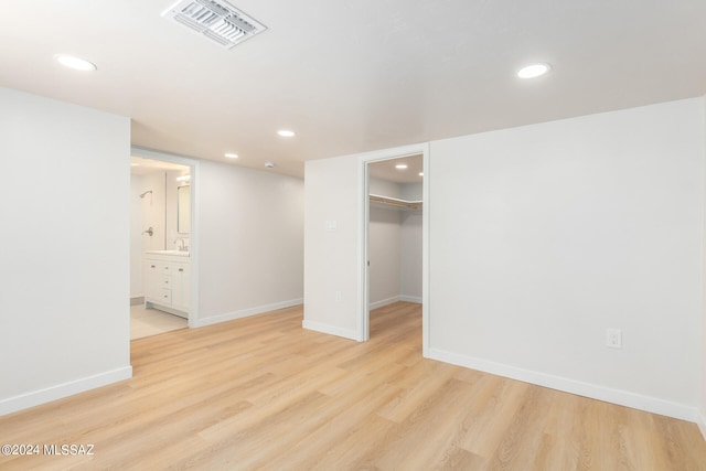 spare room with light hardwood / wood-style flooring and sink