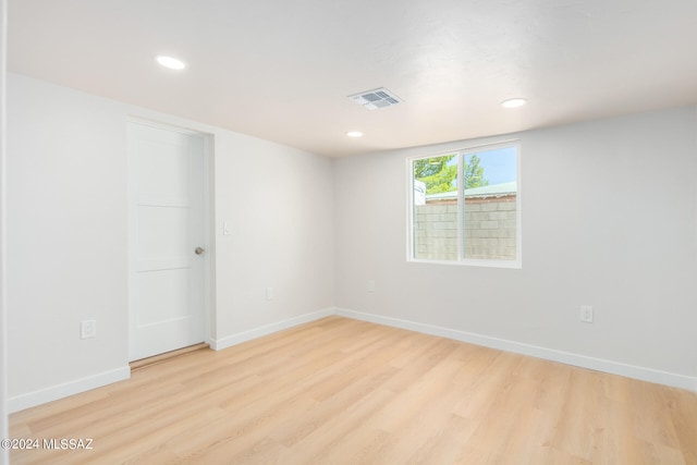 empty room with light hardwood / wood-style flooring