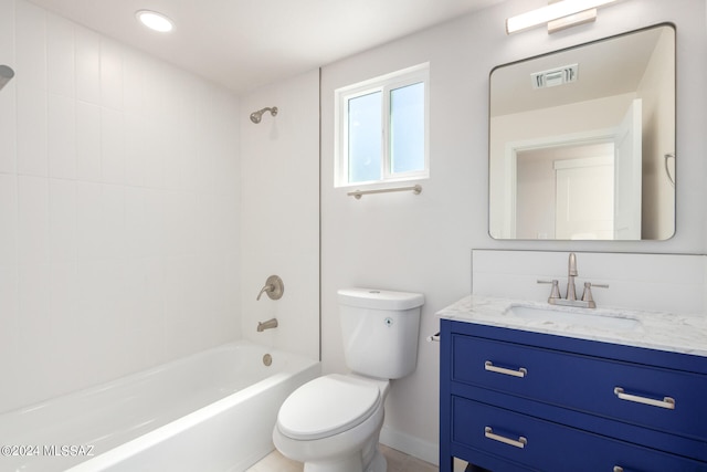 full bathroom featuring tiled shower / bath combo, vanity, and toilet