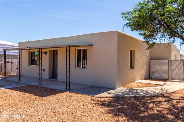 adobe home with a patio