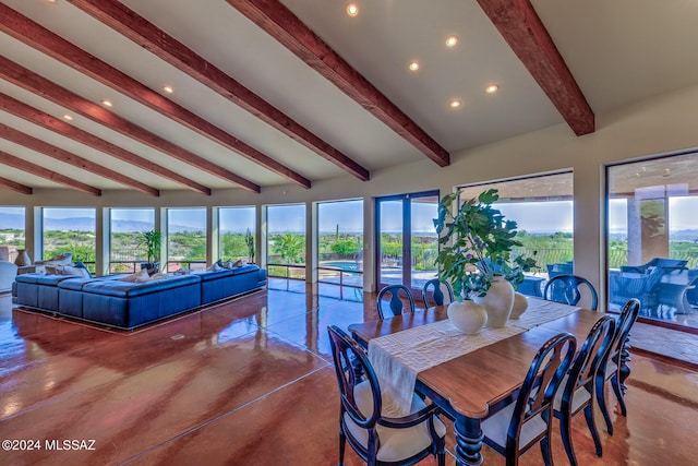 dining room featuring concrete floors and lofted ceiling with beams