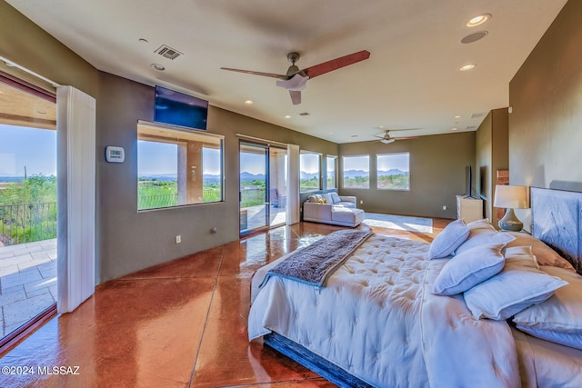 bedroom with multiple windows, access to exterior, and ceiling fan