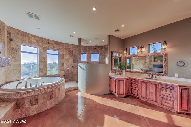 bathroom with vanity, tile patterned floors, independent shower and bath, and tile walls