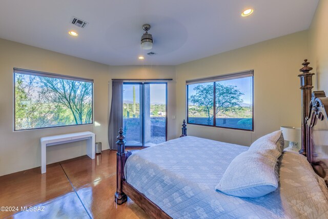 bedroom featuring multiple windows, access to outside, and ceiling fan