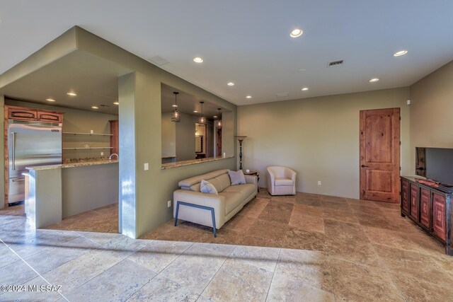 bedroom featuring recessed lighting, connected bathroom, finished concrete flooring, and visible vents