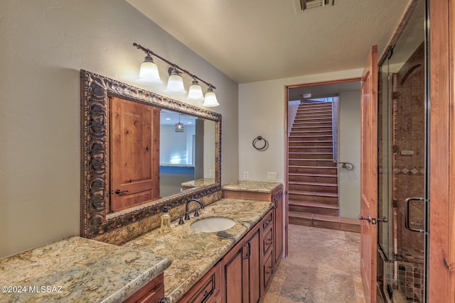 bathroom featuring vanity and an enclosed shower