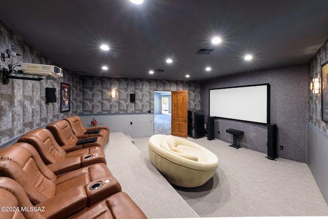 cinema featuring an AC wall unit and light colored carpet