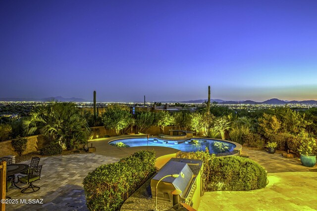 outdoor pool with a patio and stairs