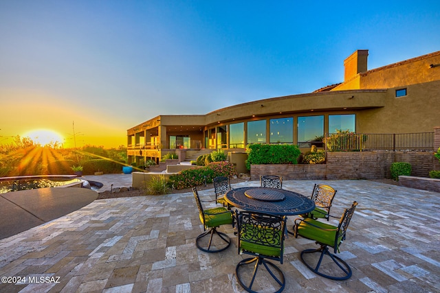 view of patio terrace at dusk