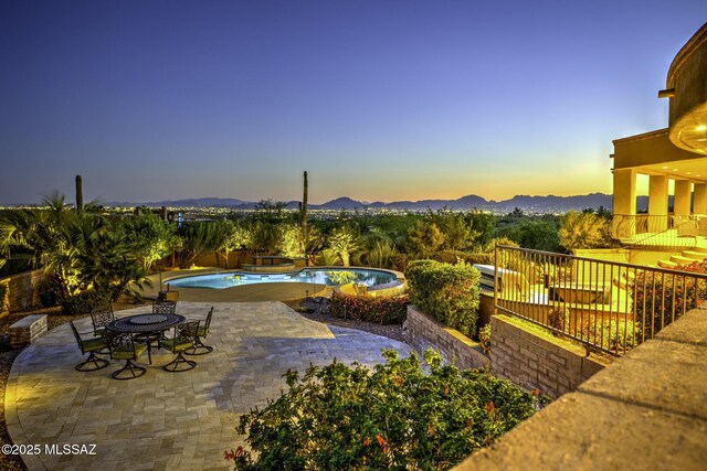 outdoor pool with stairway and a patio area