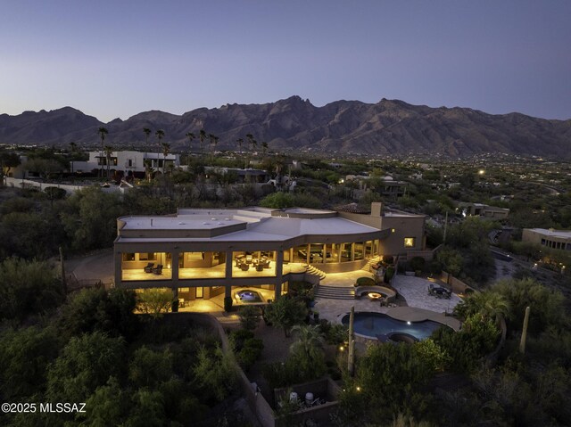 view of back of property at dusk